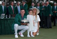 On April 13, 2025, in Augusta, Georgia, Rory McIlroy of Northern Ireland stands with the trophy, his wife Erica, and their daughter Poppy following the 2025 Masters Tournament final round at the Augusta National Golf Club during the Green Jacket ceremony. (Photo by Richard Heathcote/Getty Images)